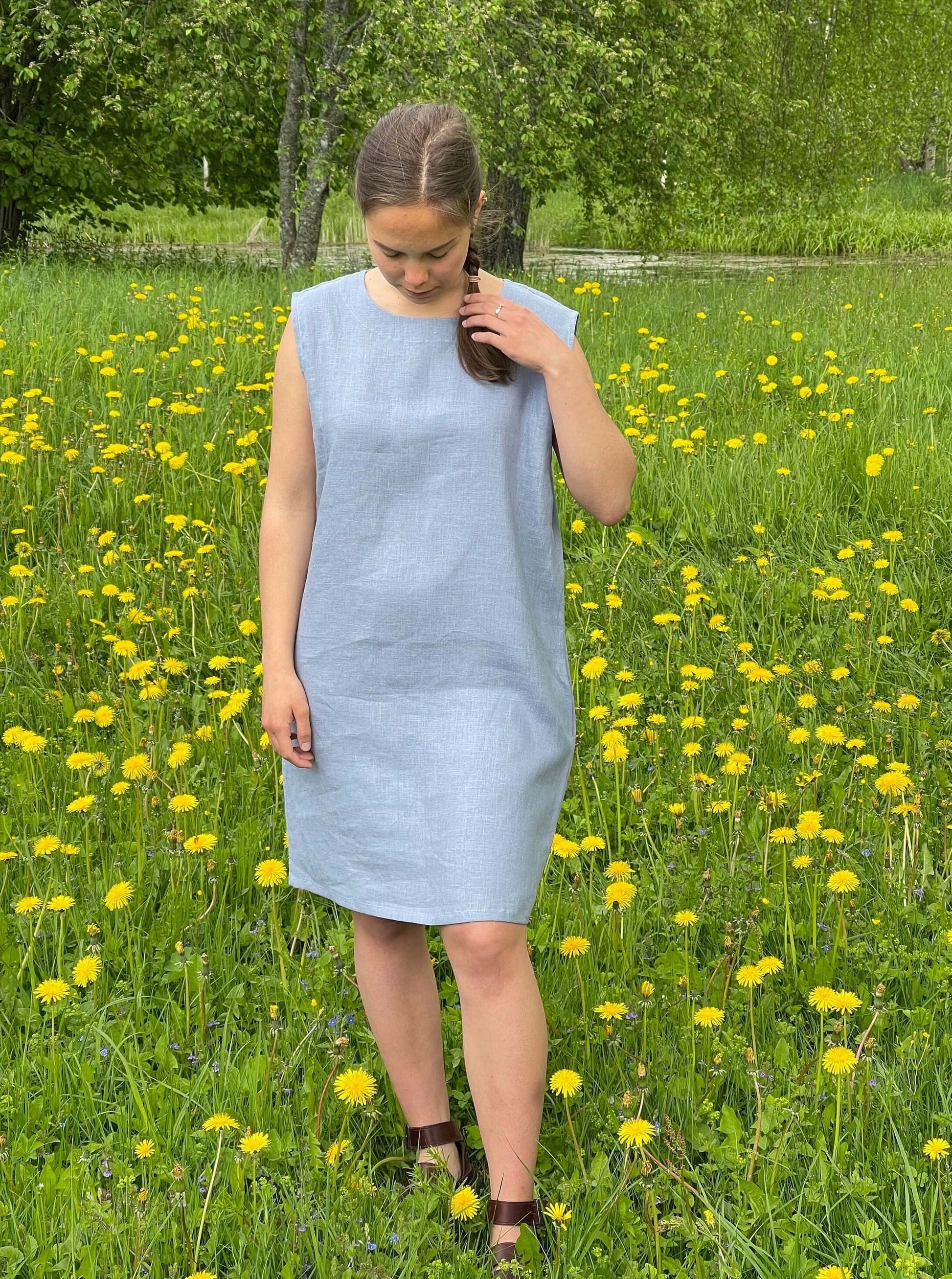 Custom fit linen dress with practical side pockets.