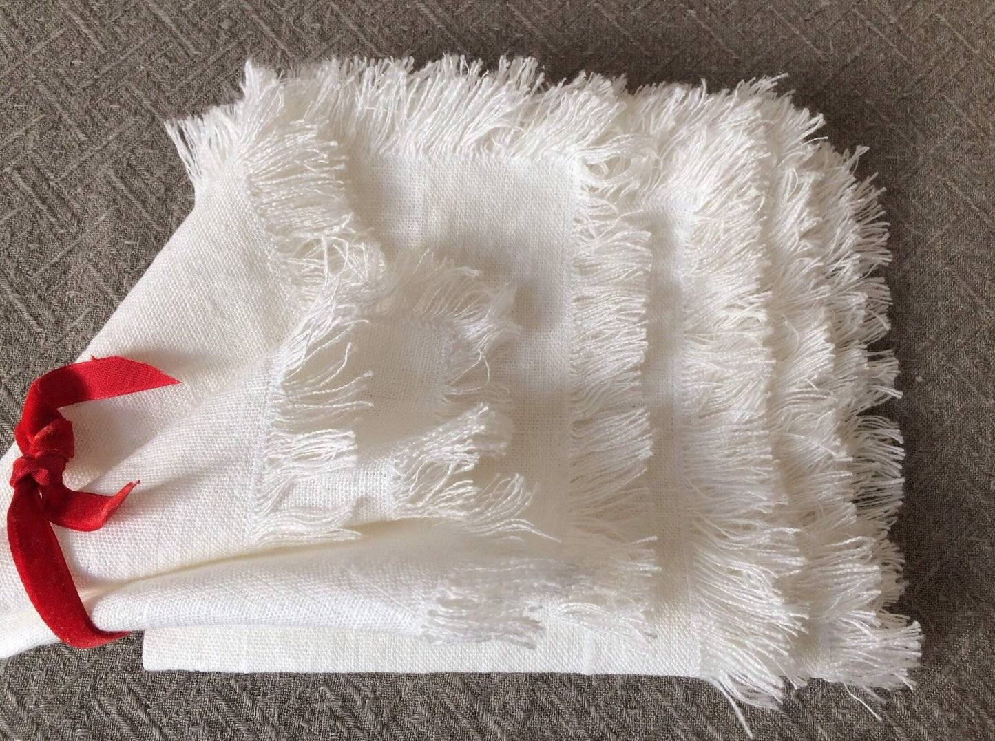 Elegant off-white linen napkins with fringe