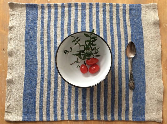 Sky blue striped linen placemat on dining table