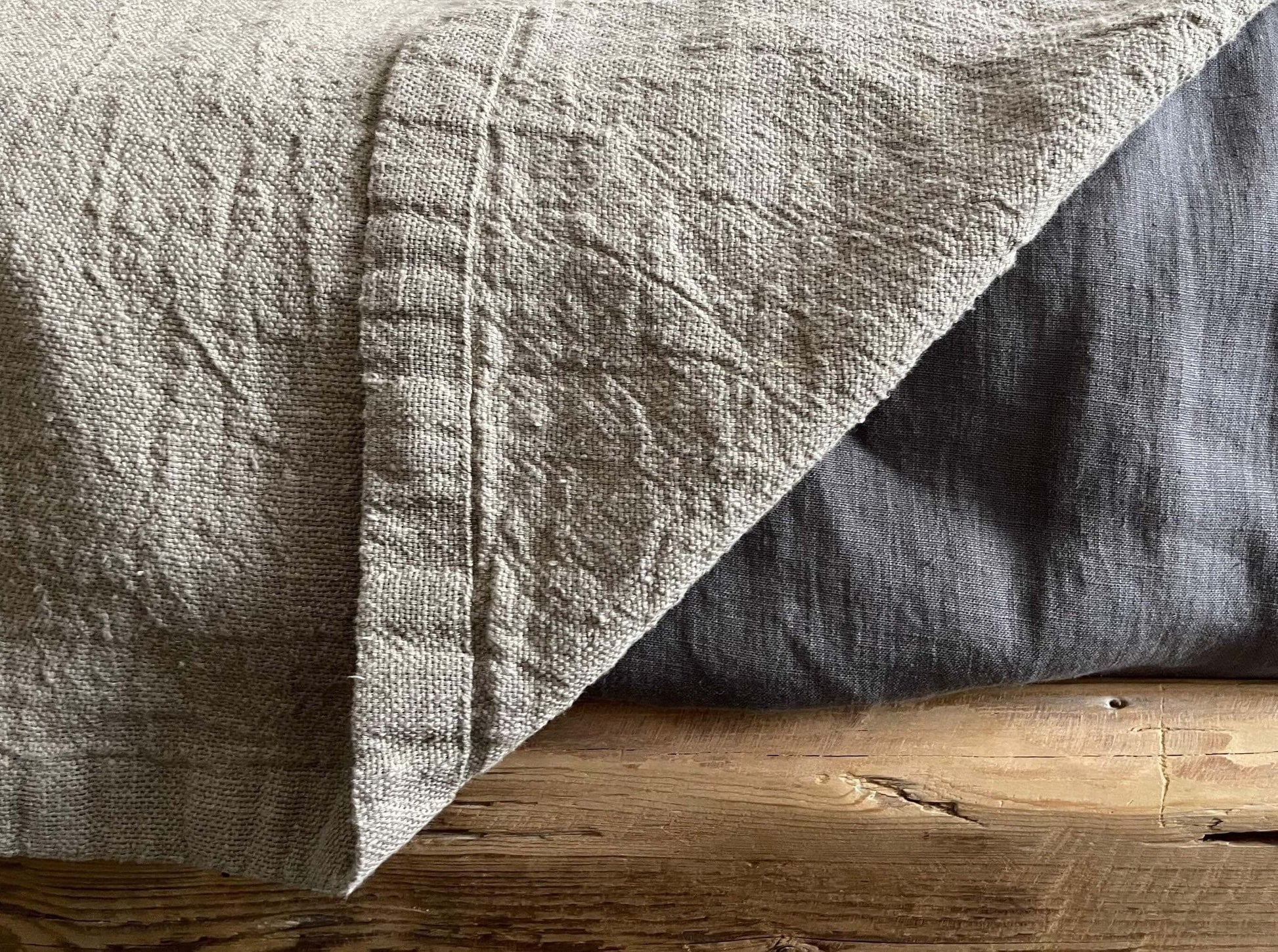 Detail of the finished edges on the Rustic Natural Linen Blanket, demonstrating its craftsmanship.